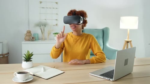 Woman Uses VR Headset at Table