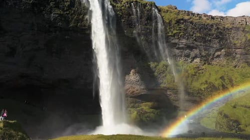 Aerial View of Iceland Volcanic Glacial Waterfall Cascading Down a Steep Cliff