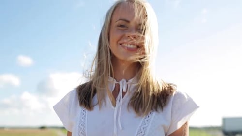Smiling Woman in White Dress on Sunny Day