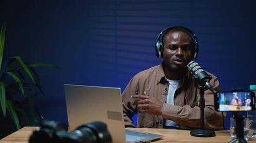 Man Recording Audio in Dark Room