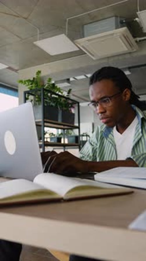 African American Student Using Laptop to Study for Exam