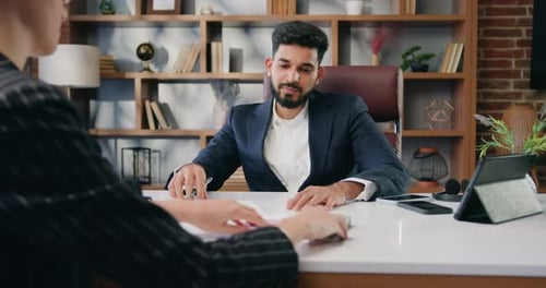 Man Writing as Woman Hands Him Money