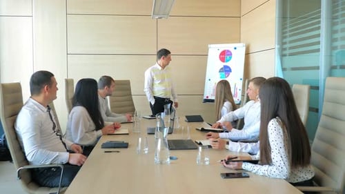 Team Meeting with Presentation in Modern Office