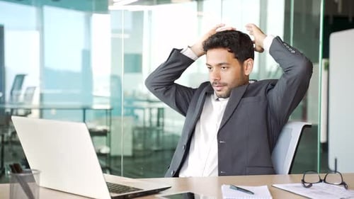 Man Working Then Relaxing At Modern Office Desk