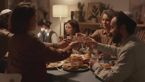 Family Members Enjoy Meal Together, Toasting With Wine