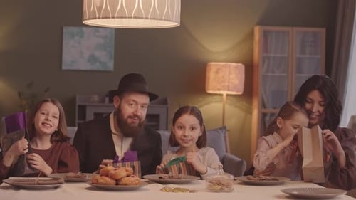 Family Celebrates Hanukkah at a Table
