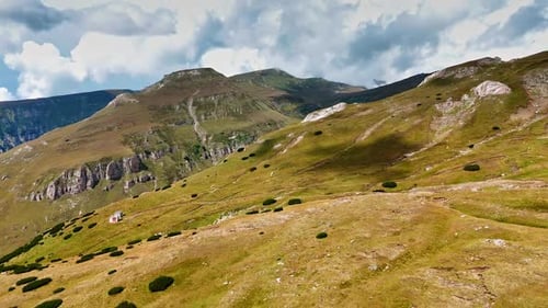 Mountain landscape under a cloudy sky.