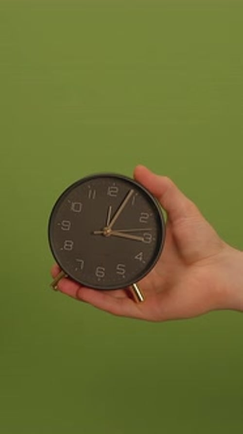 An Elegant and Stylish Clock on a Vibrant Green Background Perfect for Any Setting