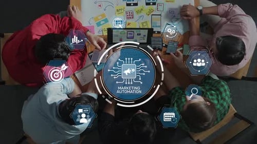 Group of professionals engaging in marketing automation strategy session with digital icons and anal