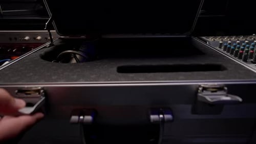 a sound engineer pulls out a microphone from a case to record a soundtrack in music studio