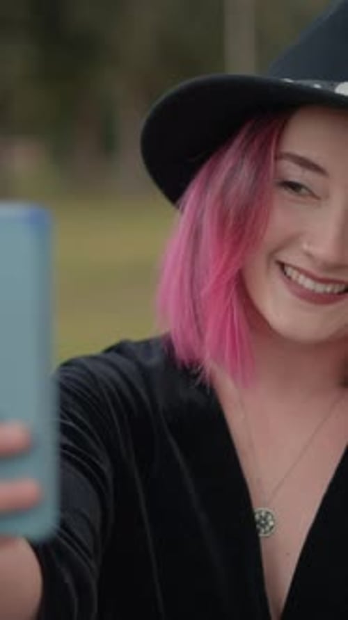 Woman with Pink Hair Taking Selfie Outdoors