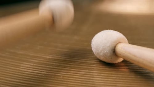 Drum Sticks Striking a Cymbal, Close Up