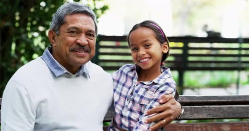 4k video footage of a grandfather bonding with his little granddaughter at the park