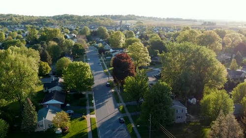 Aerial turn reveals large housing development. Magic hour sunlight reflects in beautiful spring shot