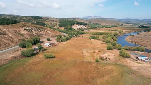 Forward flight over rural valley with fields and pond. Liucura, Lonquimay, Chile