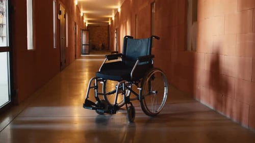 Wheelchair In Empty Hospital Corridor