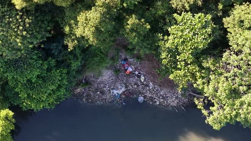 Aerial View of Polluted Riverbank in Urban Area