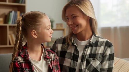 Blonde Adult and Child Bonding in a Cozy Home