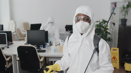 Team in Protective Suits Sanitizing Office