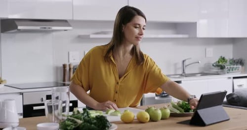 Woman Prepares Healthy Food in Modern Kitchen