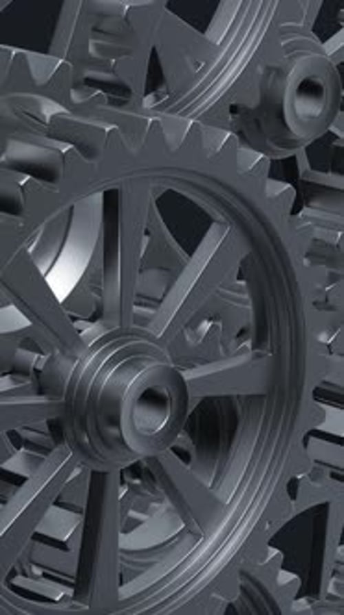 Intricate Array of Rotating Interlocking Metal Gears in CloseUp View