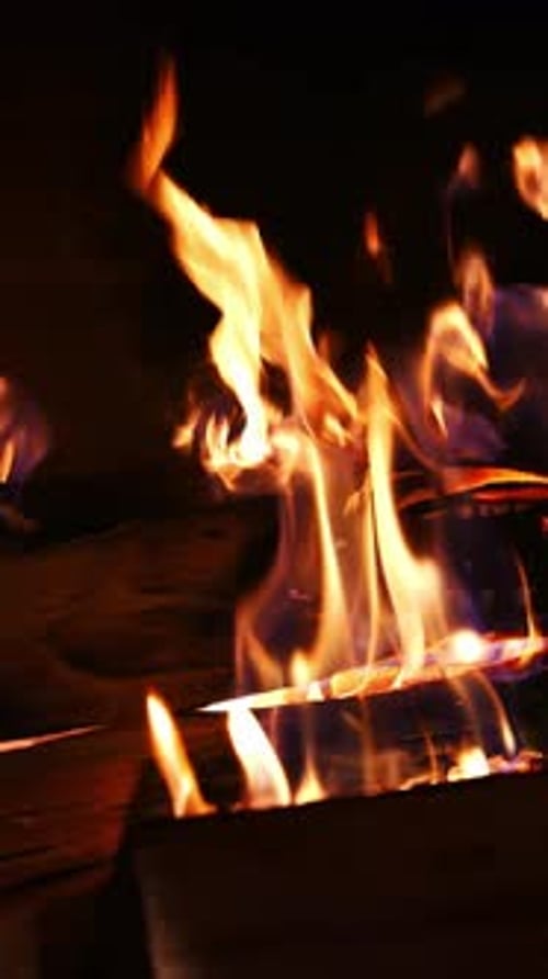 Close Up of Fiery Flames Around Burning Wood