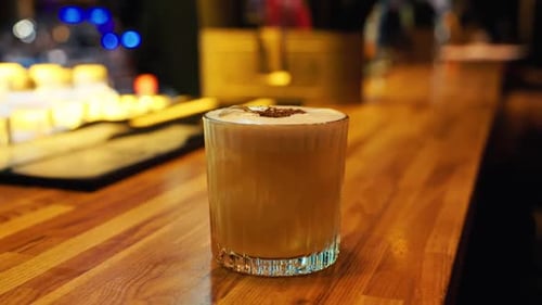 A Detailed CloseUp of a Beautiful Cocktail Displayed Elegantly on a Stylish Bar Counter in a Cozy