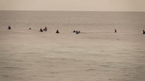 Surfing super slow motion captures young people riding waves on summer holiday