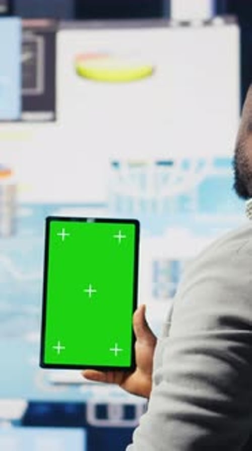 Vertical Video Entrepreneur Looks at Tablet with Chroma Key for Analysis