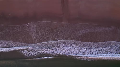 Abstract Top Down Foamy Ocean Waves Breaks Beach