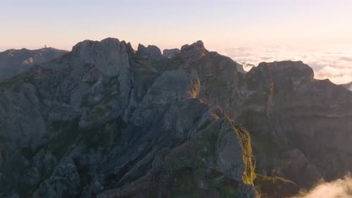 Majestic mountain range at sunrise above the clouds in a serene landscape