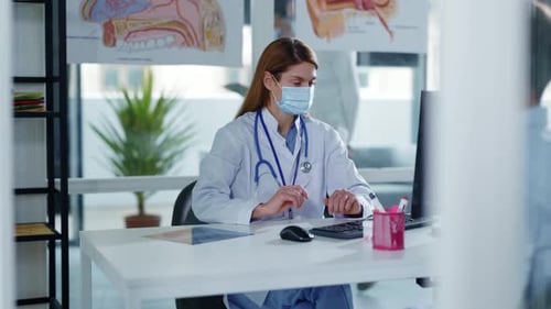 Woman Doctor Explaining X-ray to Patient in Office