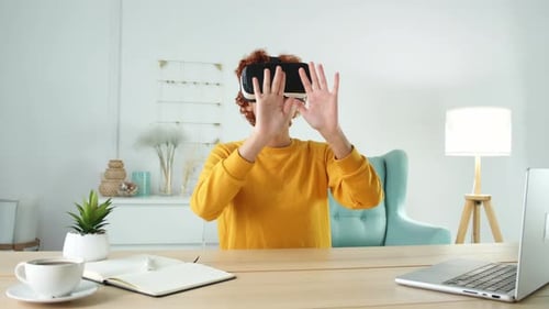 Young Adult Using Virtual Reality Headset at Desk