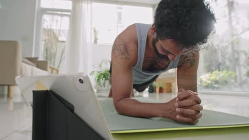 Man Doing Plank Exercise at Home on Yoga Mat