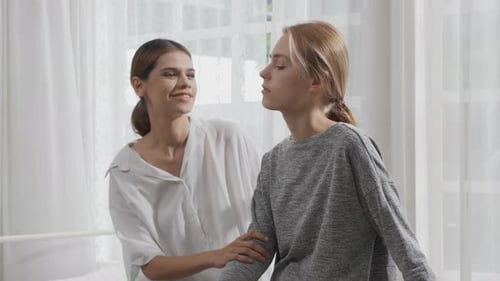 Young caucasian woman depressed while friends encourage in the bedroom at home.