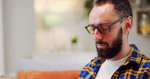 Close Up of Caucasian Man with Beard and in Eyeglasses Looking at Screen of Computer While Working