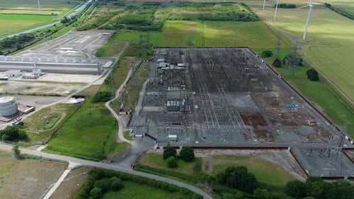 Explore the complex network of an industrial power station from above, located in the UK.