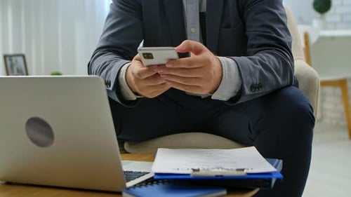Businessman Working on Laptop in Modern Office Setting