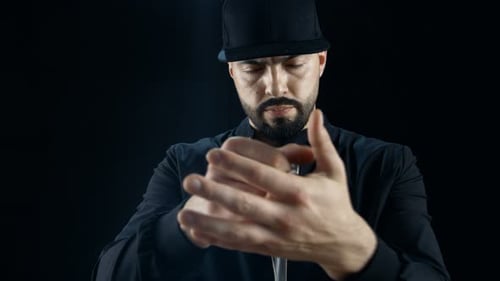 Professional Street Magician in a Cap Performs Card Disappearance and Appearance Sleight of Hand Tr