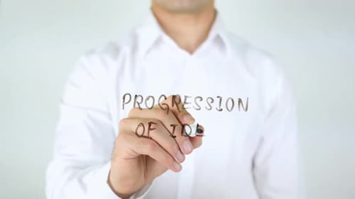 Man Writes Progression of Idea on Clear Surface