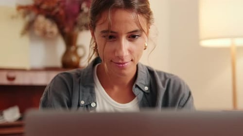 Young Woman Working on Laptop in Home