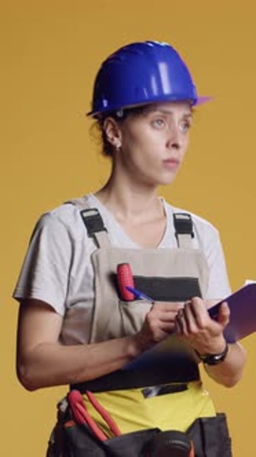 Vertical Video Portrait of Construction Worker Taking Notes and Doing Architecture Measurement