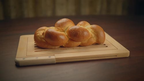 Freshly Baked Braided Bread on a Wooden Cutting Board Creating an Appetizing and Artisanal Image