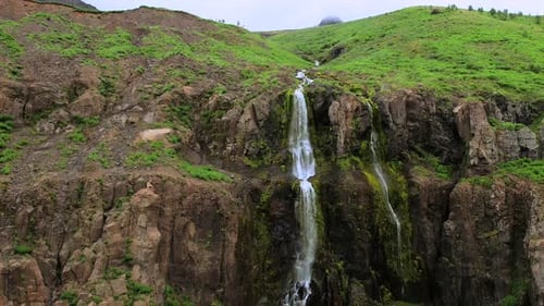 Close-Up of Búðareyrarfoss Waterfall Cascading Down Rocky Cliffs in Seyðisfjörður Iceland