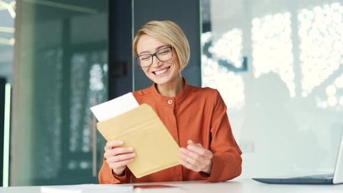Woman Receives Good News in an Envelope