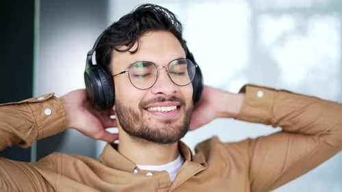 Happy Man Listening to Music With Headphones