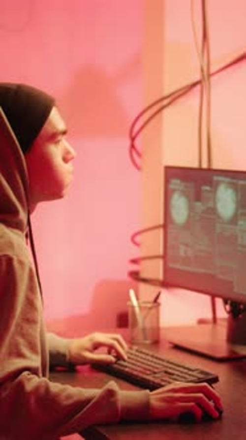 Young Adult Working at Computer at Night