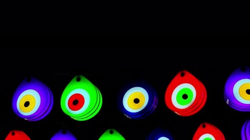 Colorful Evil Eye Charms Glowing on a Dark Background
