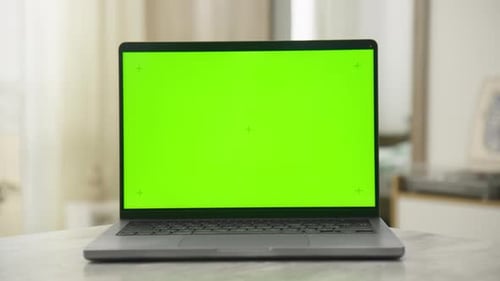 Laptop with Green Screen for Mockup in Bright Indoor Setting