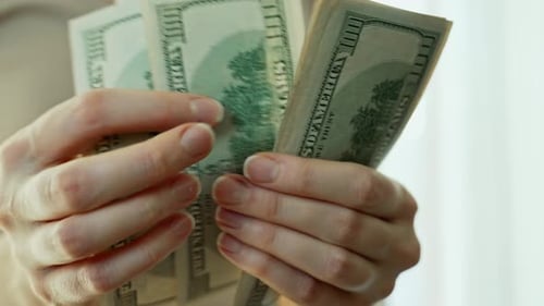 Counting Hundred Dollar Bills in Bright Light